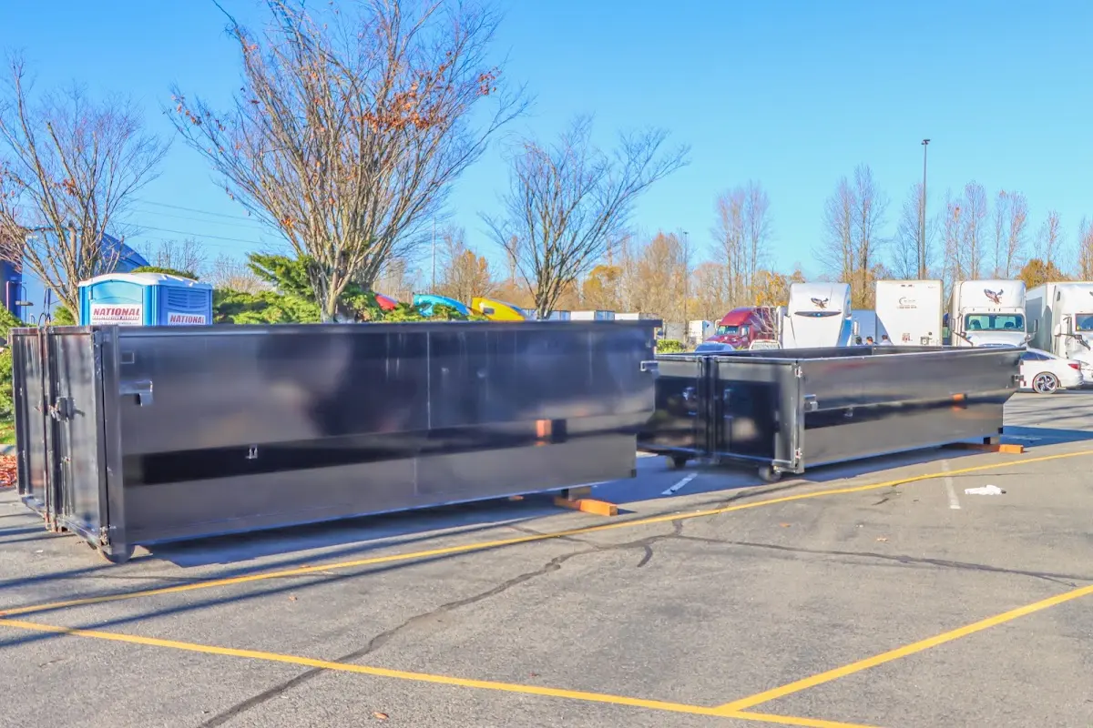 Professional dumpster rental service with roll-off container on residential driveway in Fredericksburg